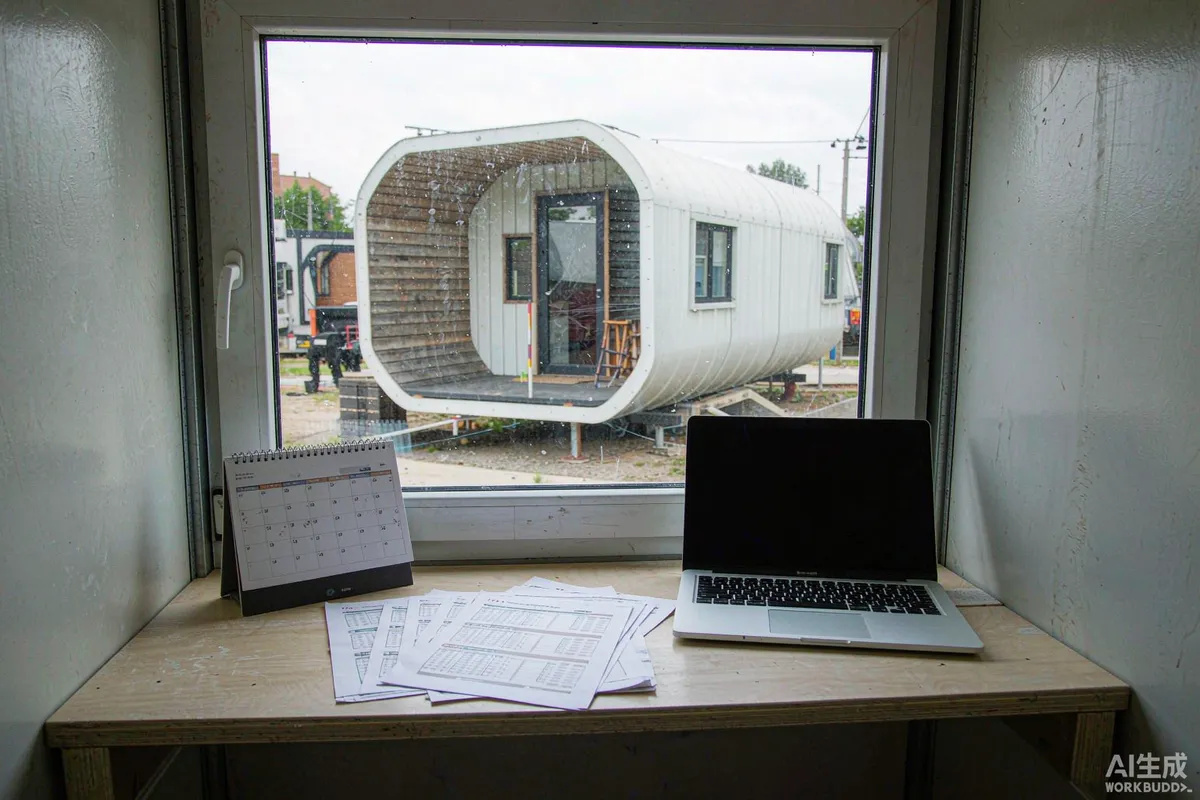 Site office desk with calendar, laptop and printed booking reports, capsule home outside the window