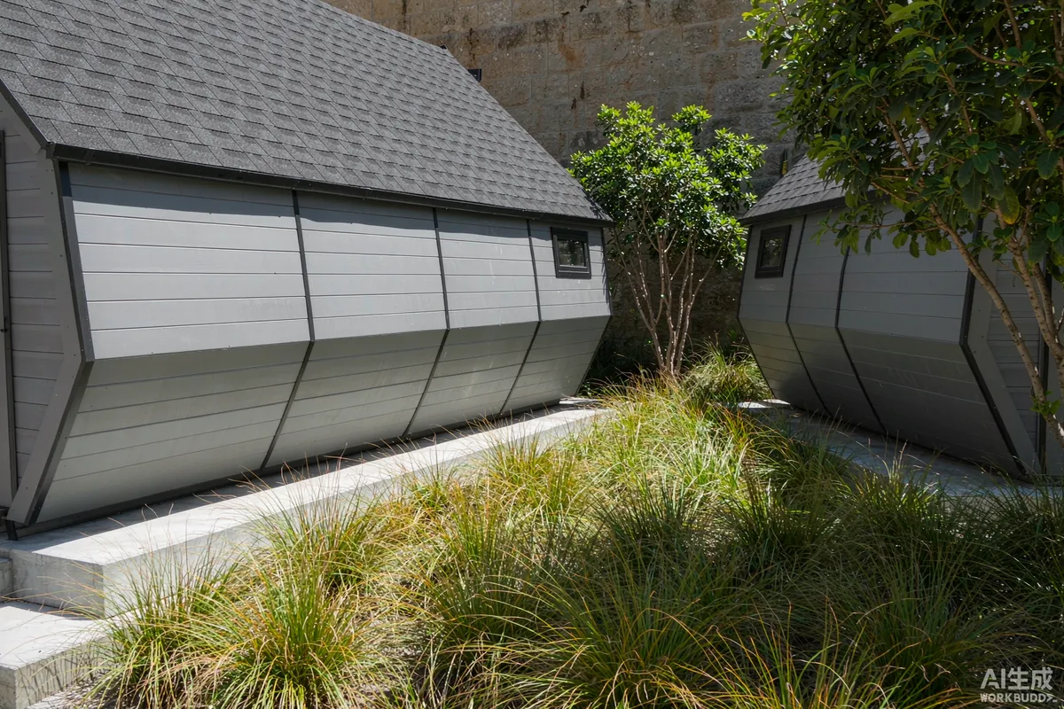Two prefab capsule homes placed at an offset angle and screened from each other by ornamental grasses and young trees
