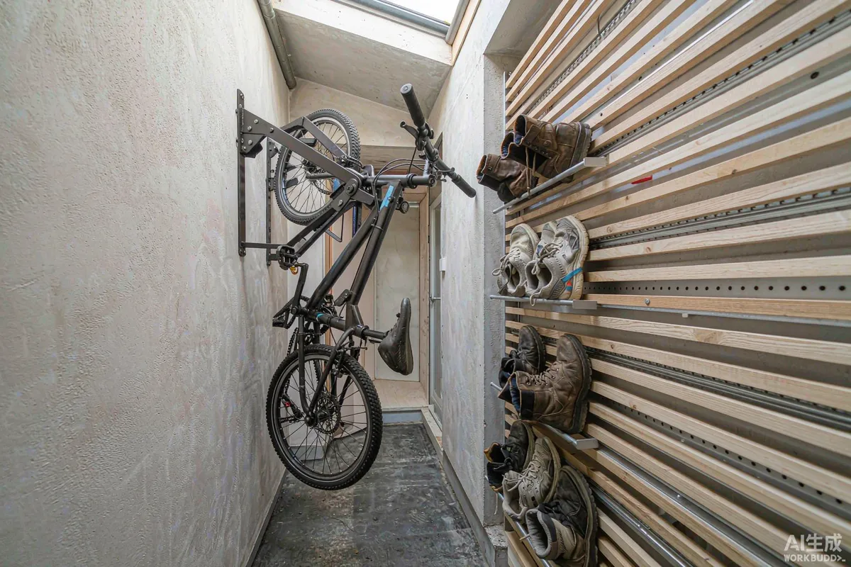 Wall-mounted bicycle rack and slatted boot drying bench in a covered entry porch of a capsule home