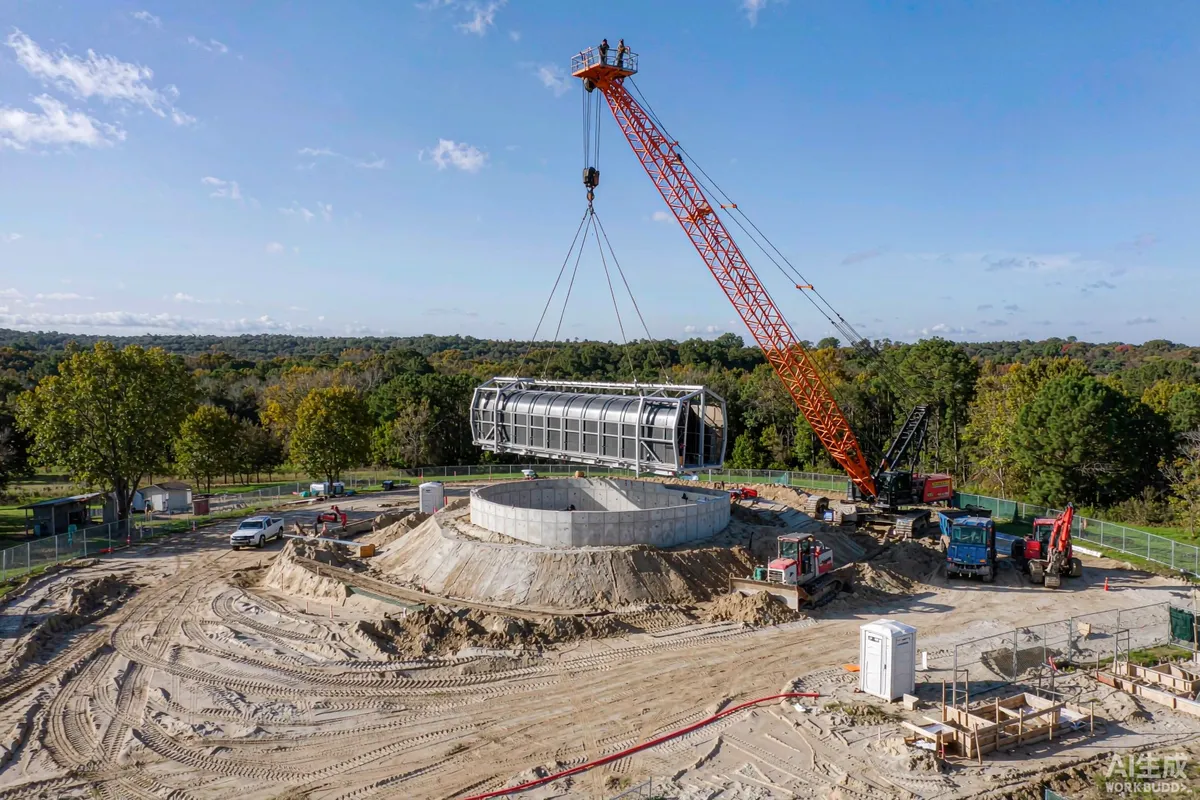 Crane lifting a prefab capsule home onto a prepared foundation on a rural plot