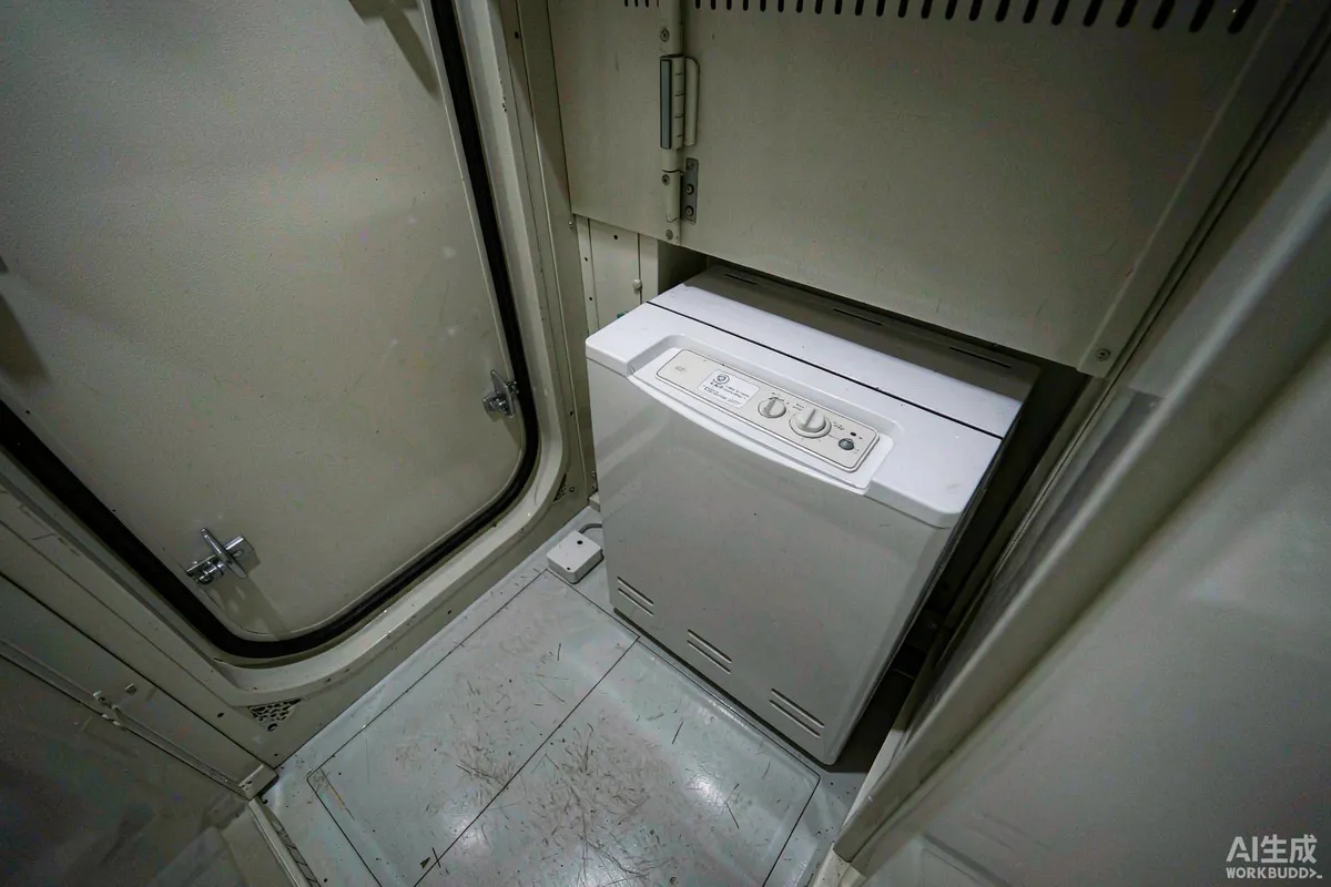 White water leak sensor on the floor beside a compact electric water heater inside a prefab capsule utility cupboard