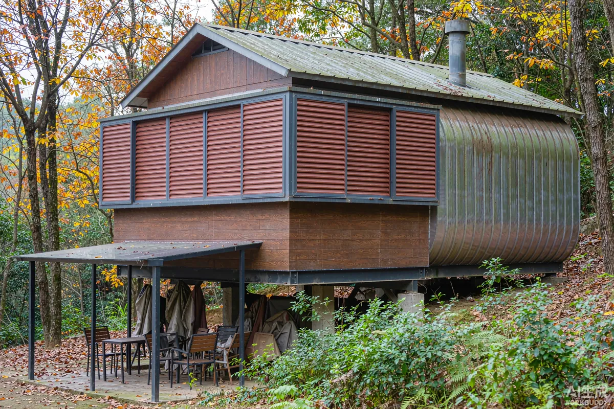 Capsule home in autumn woodland with protective shutters and covered outdoor furniture before winter